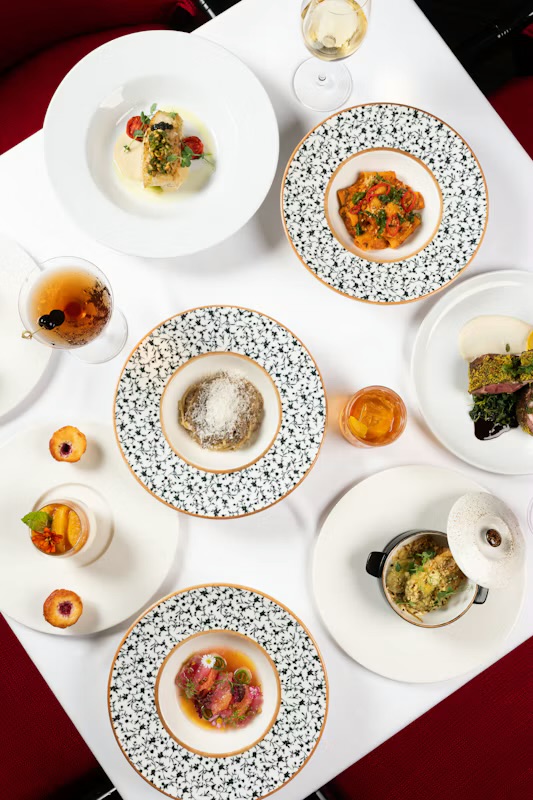 An overhead presentation of Palio dishes representing Chef Charles Davis’s culinary work at Wyndham Grand Rio Mar